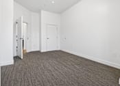 Thumbnail 52 of 52 - A room with a carpeted floor and white walls.