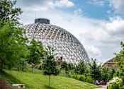 Thumbnail 30 of 34 - A large dome structure is surrounded by trees and grass.