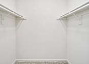 Thumbnail 60 of 61 - A white hallway with a carpeted floor and white walls.