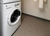 Thumbnail 46 of 50 - A white washing machine and dryer stacked on top of each other in a laundry room.