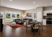 Thumbnail 4 of 35 - A modern kitchen with a dining table set for four.