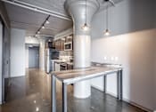 Thumbnail 5 of 35 - A modern kitchen with a large island in the middle.