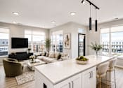 Thumbnail 2 of 40 - A modern kitchen with a large island and a view of the city.