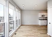 Thumbnail 8 of 34 - A room with a wooden floor and white walls.