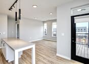 Thumbnail 10 of 34 - A modern kitchen with a large island and a view of the city.