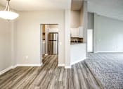 Thumbnail 30 of 61 - an empty living room and kitchen with wood flooring at Autumn Grove Apartments, Omaha, NE