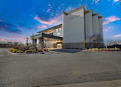 Thumbnail 1 of 52 - Upscale studio, one, and two-bedroom apartment homes featuring two-tone kitchen cabinetry, quartz countertops, stainless steel appliances, luxury vinyl wood flooring, and much more at Parkside Apartments and Shops in Bentonville, AR