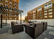 Thumbnail 5 of 19 - a patio with chairs and a fire pit