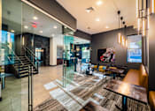 Thumbnail 32 of 37 - A modern lobby with a glass wall and a staircase.