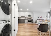 Thumbnail 39 of 43 - A modern kitchen with a washing machine in the foreground.