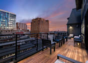 Thumbnail 10 of 21 - a rooftop terrace with a view of the city at sunset at 520 Lofts, Allentown, PA