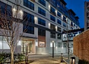 Thumbnail 19 of 21 - an apartment building at night with a sidewalk and benches at 520 Lofts, Allentown