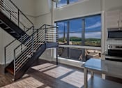 Thumbnail 18 of 21 - a large living room with a staircase and large windows at 520 Lofts, Allentown, Pennsylvania