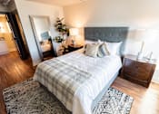 Thumbnail 16 of 22 - A bedroom with a large bed and a mirror on the wall at Cityplace Apartment Homes Apartments, Pennsylvania