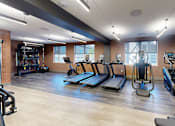 Thumbnail 18 of 35 - A gym with treadmills, elliptical machines, and other exercise equipment at The Standard Apartments, Pennsylvania