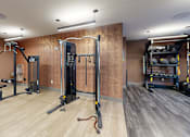 Thumbnail 17 of 35 - A gym with a variety of equipment including a squat rack, a leg press machine, and a bench press at The Standard Apartments, Allentown