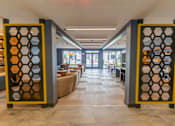 Thumbnail 18 of 26 - A hallway with a yellow and black gate divider at The Hive Apartments, Allentown, PA