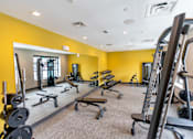 Thumbnail 5 of 26 - A gym with a variety of equipment including weights and cardio machines. at The Hive Apartments, Allentown, PA, 18101