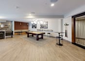 Thumbnail 22 of 35 - A room with a long wooden table and chairs at The Standard Apartments, Allentown, Pennsylvania