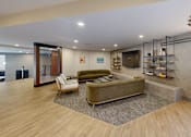 Thumbnail 21 of 35 - A modern living room with a green sofa and a wooden floor at The Standard Apartments, Allentown, 18101