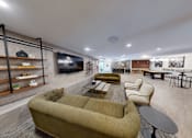 Thumbnail 20 of 35 - A living room with a green couch and a television at The Standard Apartments, Allentown, PA