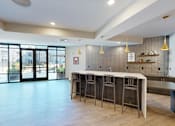 Thumbnail 23 of 35 - A bar area with a row of stools and a counter at The Standard Apartments, Allentown