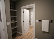 Thumbnail 9 of 15 - A white door is open to a hallway.