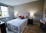 Thumbnail 8 of 15 - A bedroom with a large bed and a window.