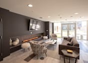 Thumbnail 14 of 16 - a living room with a couch and chairs and a fireplace