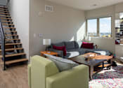 Thumbnail 16 of 16 - a living room with a couch and chairs and a staircase