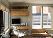 Thumbnail 2 of 16 - a home office with a desk and a large window