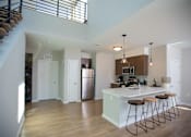 Thumbnail 8 of 16 - an open kitchen with a large island with stools