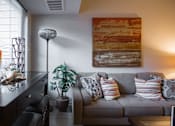 Thumbnail 2 of 10 - a living room with a couch and a painting on the wall