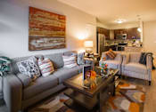 Thumbnail 4 of 10 - a living room with a couch and a table