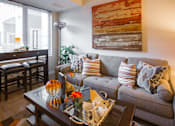 Thumbnail 5 of 10 - a living room with a couch and a coffee table