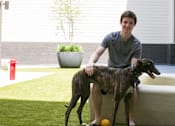 Thumbnail 7 of 10 - a man sitting on a couch with his two dogs
