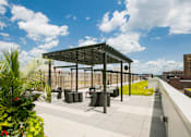 Thumbnail 16 of 19 - a roof terrace with tables and chairs and a pergola on a rooftop