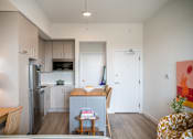 Thumbnail 7 of 58 - A kitchen with a refrigerator, microwave, and oven.at The Teale Golden Gate in Naples, FL, 34116