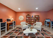 Thumbnail 40 of 58 - A living room with a white coffee table and a rug with a pattern of squares and rectangles.