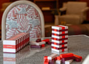 Thumbnail 47 of 58 - A table with a stack of red and white cups and a pile of red blocks on it.