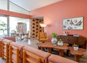 Thumbnail 51 of 58 - A living room with a pink wall and wooden furniture.