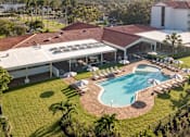 Thumbnail 15 of 58 - A large building with a pool in front.