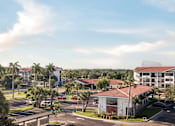 Thumbnail 35 of 58 - A view of a residential area with apartment buildings and cars parked in the driveways.