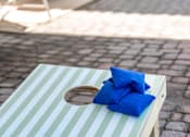 Thumbnail 31 of 58 - A wooden table with a blue pillow on it.