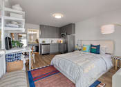 Thumbnail 20 of 21 - studio apartment bed desk and kitchen at The Teale Navy Yard, North Charleston, South Carolina