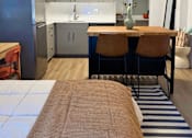 Thumbnail 2 of 16 - A kitchen with a refrigerator, sink, and cabinets at The Teale Siesta Lago in Kissimmee, FL, 34746