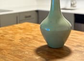 Thumbnail 7 of 16 - A green vase with flowers on a wooden table in a kitchen at The Teale Siesta Lago in Kissimmee, FL, 34746