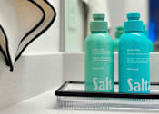Thumbnail 6 of 16 - Two bottles of salt water are on a shelf at The Teale Siesta Lago in Kissimmee, FL, 34746