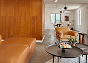 Thumbnail 10 of 16 - A living room with a brown leather couch and a wooden wall. at The Teale Siesta Lago in Kissimmee, FL, 34746