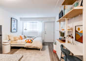 Thumbnail 2 of 11 - a bedroom with a bed and a desk in a small room at The Teale, Kissimmee, FL, 34746